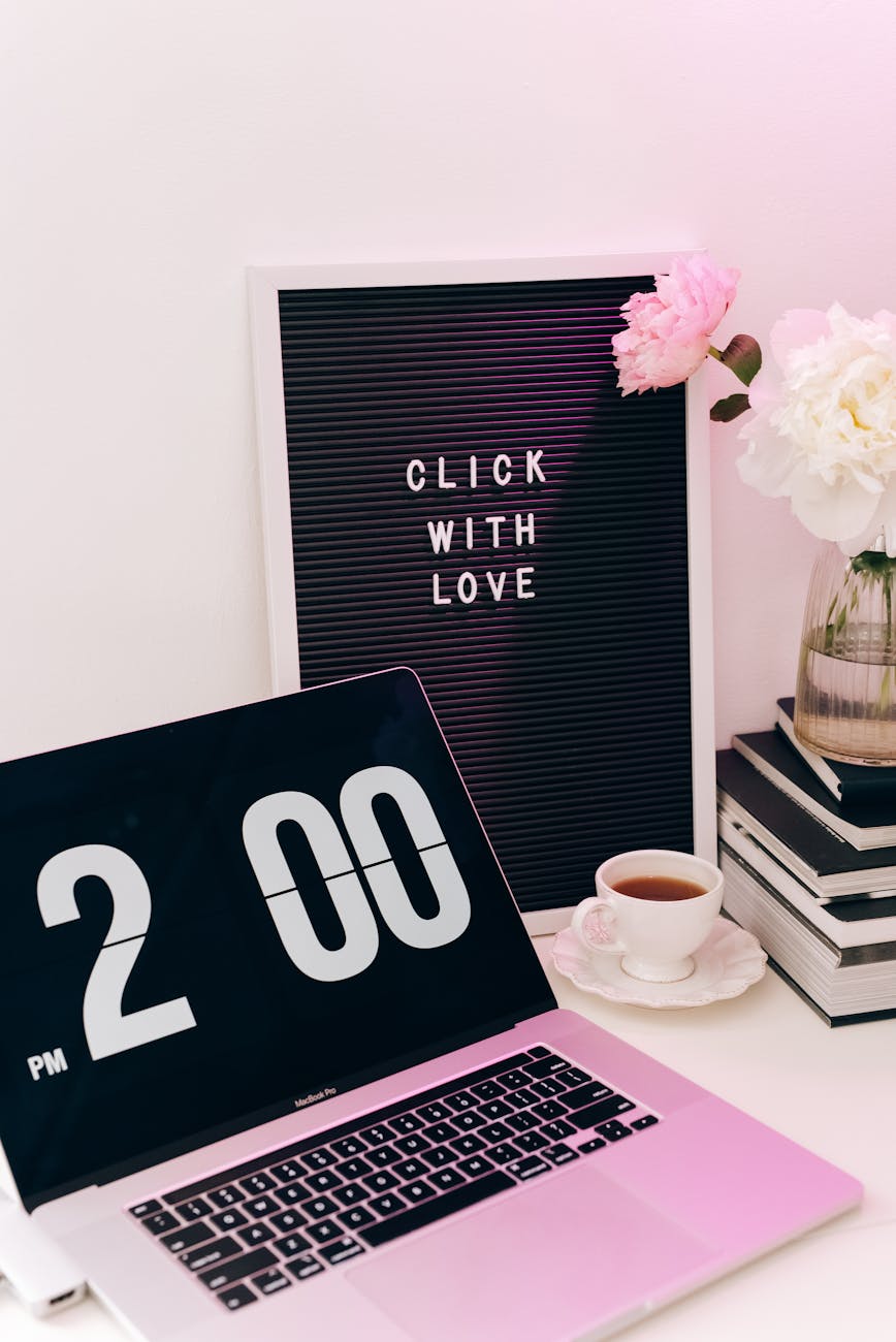 a laptop beside a frame