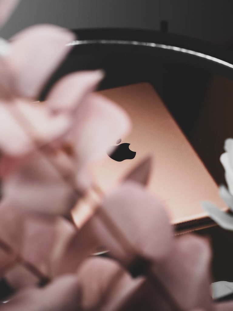 apple logo behind flowers petals